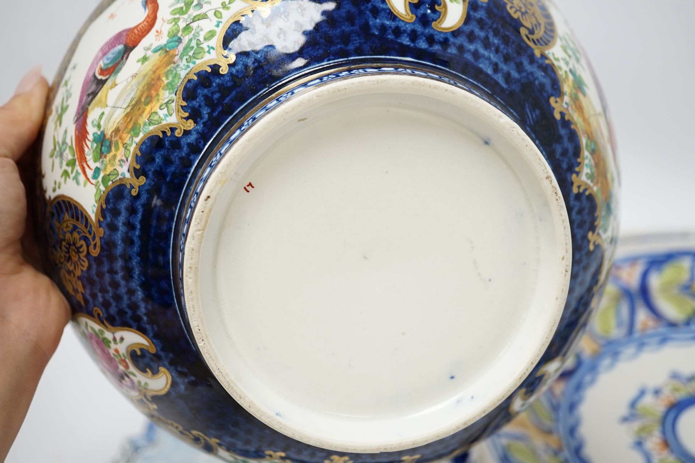 A Delft blue and white plaque, two continental tin-glazed dishes, one signed V.M.D, and a Booths scale-blue bowl, largest 35cm in diameter. Condition - largest dish poor, others fair
